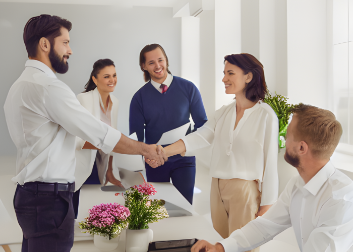 Floral industry job interview: Woman confidently shaking hands with HR interviewer